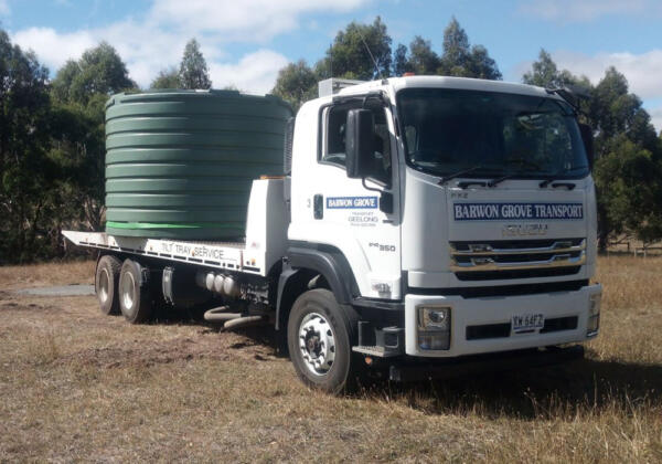 Freight transportation - truck transporting agricultural equipment and water tank in Geelong