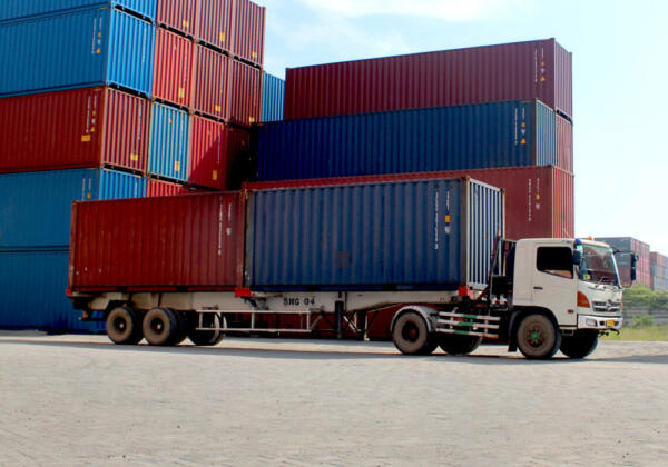 A truck carrying shipping containers at a port facility in Geelong